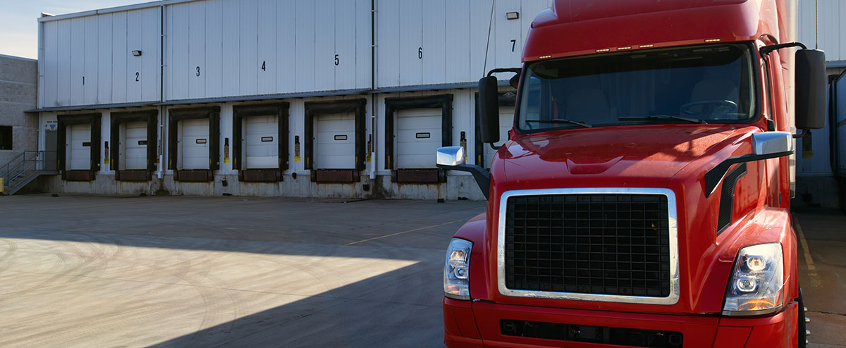 semi truck parked at warehouse waiting to pickup a load